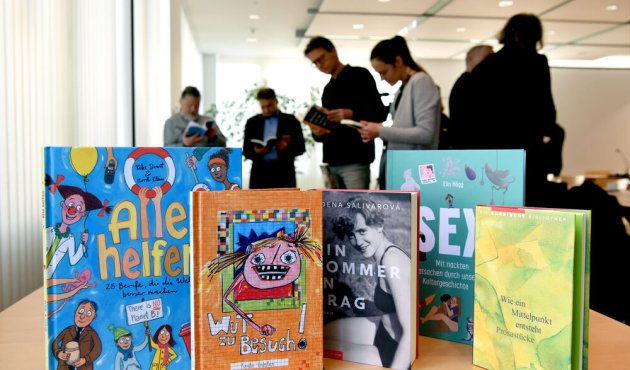 Besucher schauen Bücher an beim Pressegespräch der Verlage aus SaSaThü