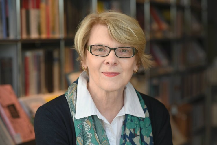 Regula Venske mit Brille vor Bücherregal